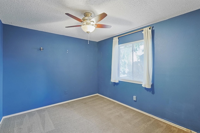 carpeted empty room featuring a textured ceiling and ceiling fan