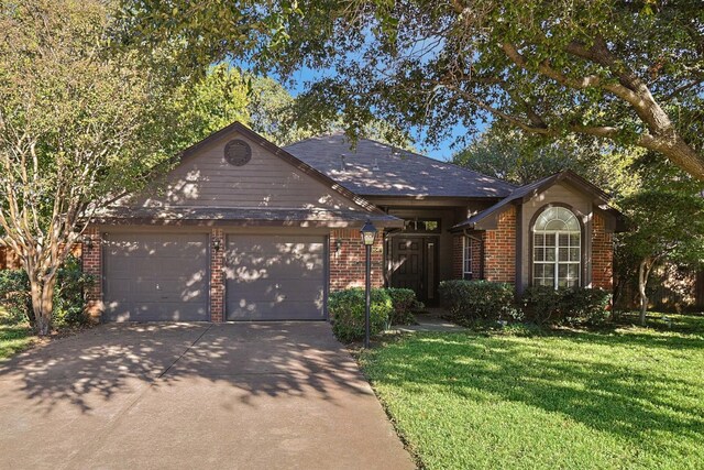 single story home with a front yard and a garage