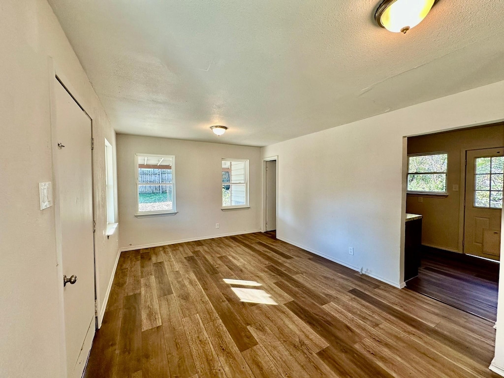 spare room with hardwood / wood-style floors and a textured ceiling