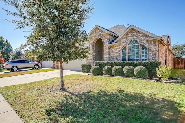 view of front of property featuring a garage and a front yard