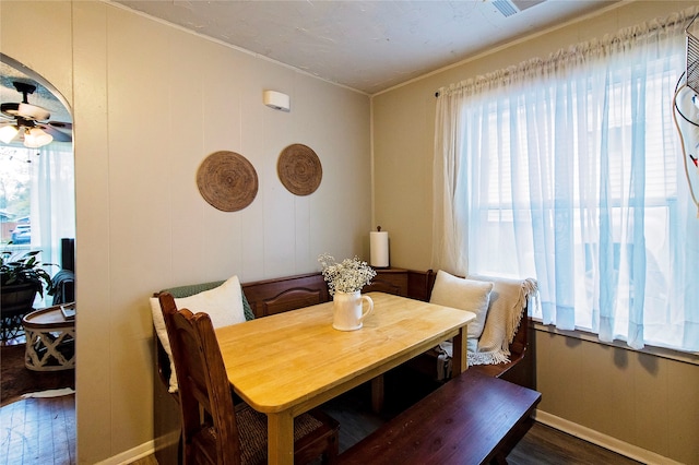 dining area featuring ceiling fan, dark hardwood / wood-style flooring, ornamental molding, and a wealth of natural light