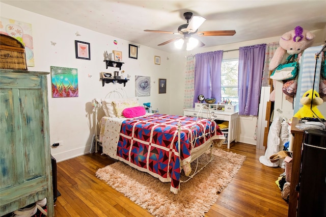 bedroom featuring hardwood / wood-style flooring and ceiling fan