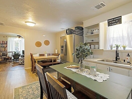 dining space with sink and light hardwood / wood-style flooring