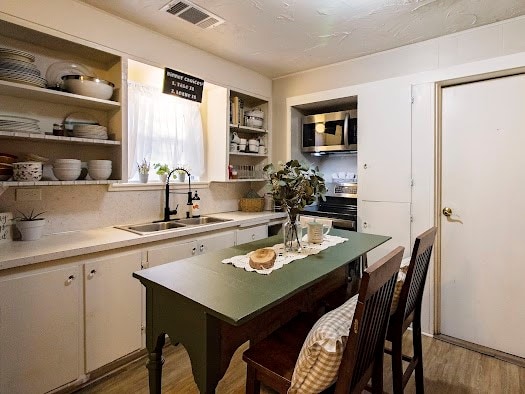 kitchen featuring sink, white cabinets, stainless steel appliances, and dark hardwood / wood-style floors