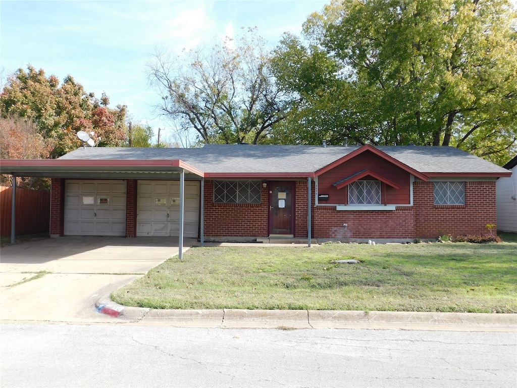 ranch-style home with a garage and a front yard