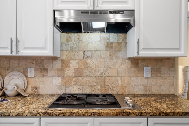 kitchen featuring stainless steel gas cooktop, white cabinetry, exhaust hood, and tasteful backsplash