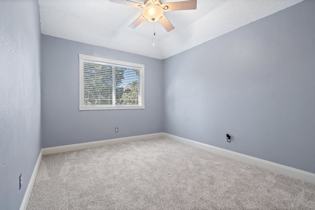 empty room with carpet flooring, ceiling fan, and a textured ceiling