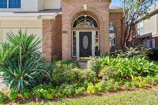 view of exterior entry with a garage