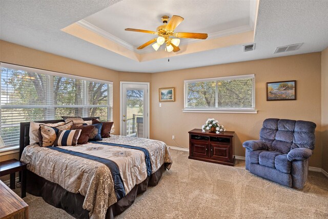 bedroom with multiple windows, ceiling fan, and light colored carpet