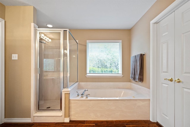 bathroom featuring hardwood / wood-style floors and independent shower and bath