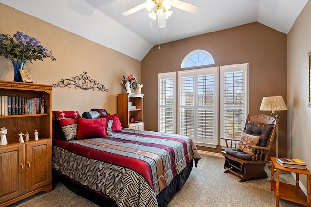 carpeted bedroom featuring ceiling fan, vaulted ceiling, and multiple windows