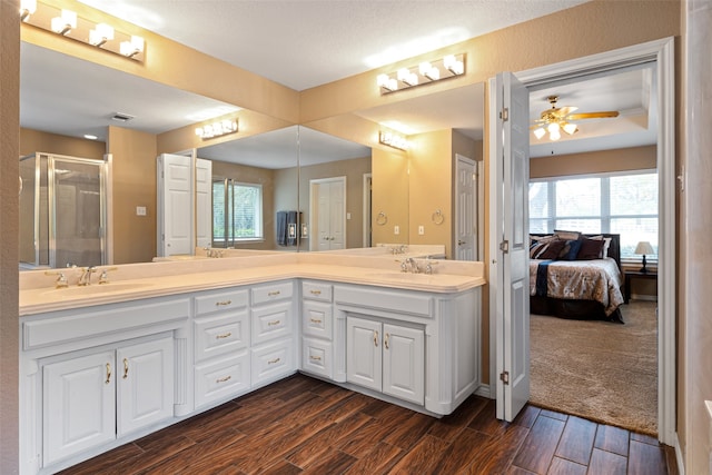 bathroom featuring vanity, hardwood / wood-style flooring, a wealth of natural light, and ceiling fan