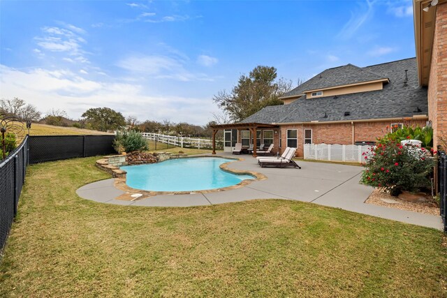 view of pool with a yard and a patio