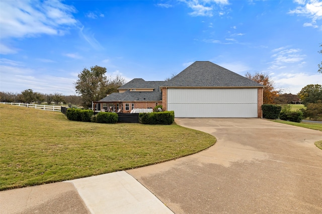 view of front of property with a garage and a front lawn