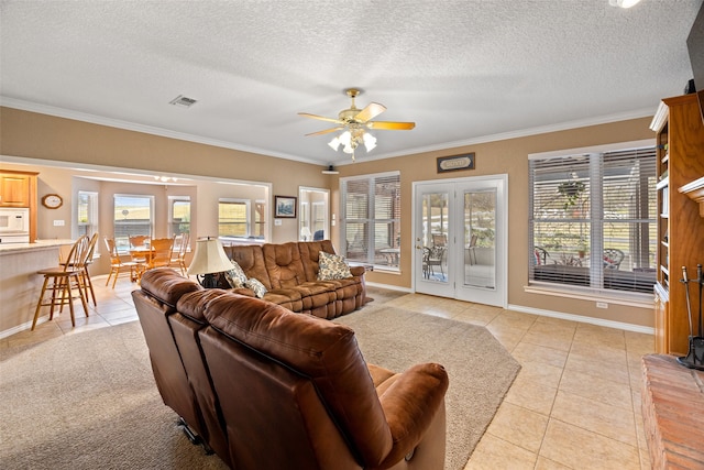 living room with ceiling fan, light tile patterned flooring, and a textured ceiling