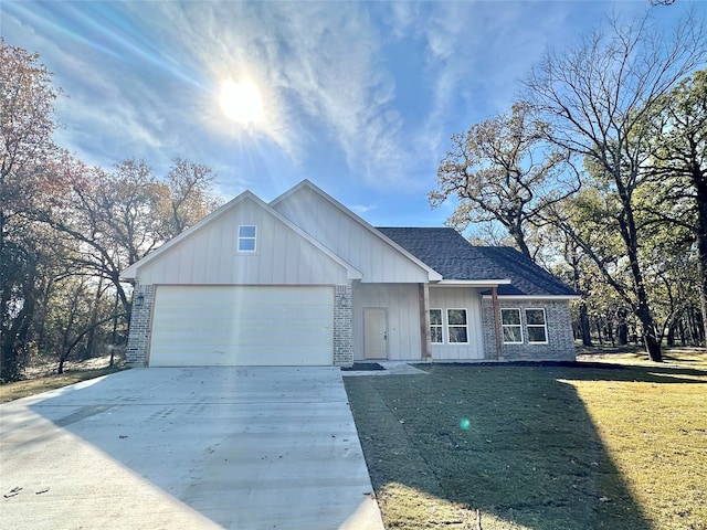 view of front of property with a front yard and a garage