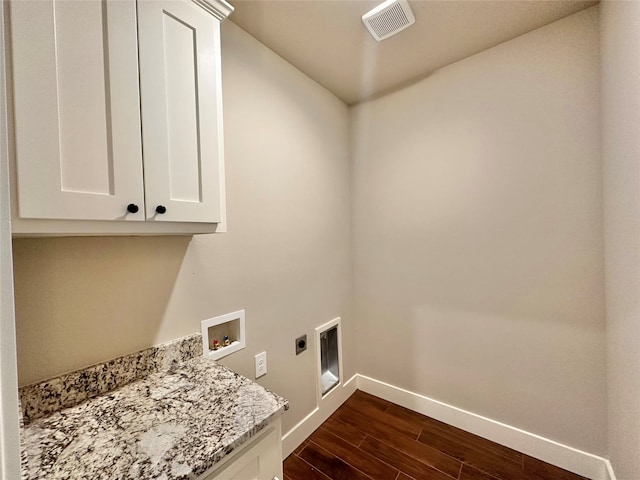 clothes washing area featuring cabinets, washer hookup, dark hardwood / wood-style flooring, and hookup for an electric dryer