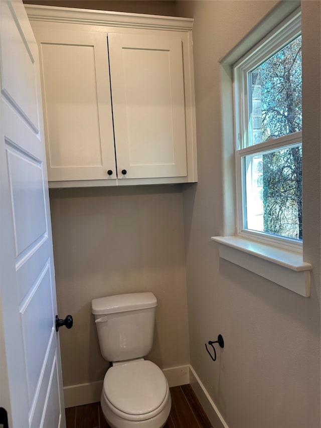 bathroom with toilet and hardwood / wood-style flooring