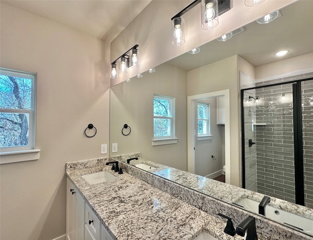 bathroom featuring an enclosed shower, vanity, and toilet