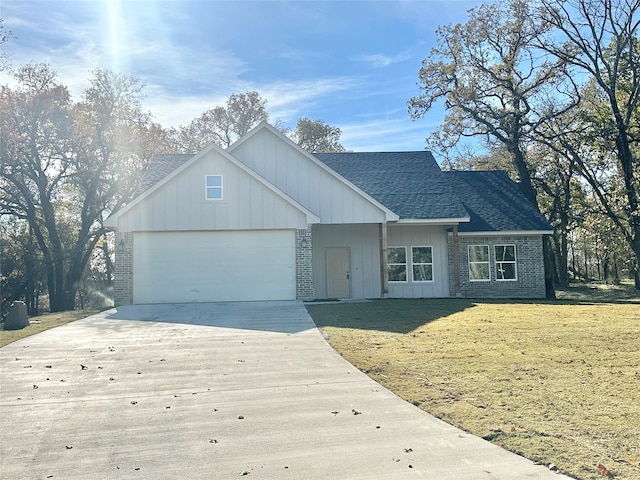 view of front facade with a front yard and a garage