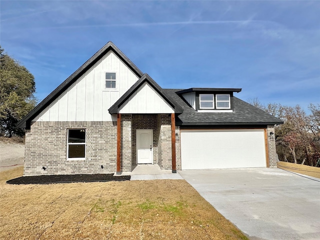 view of front of home with a front yard and a garage