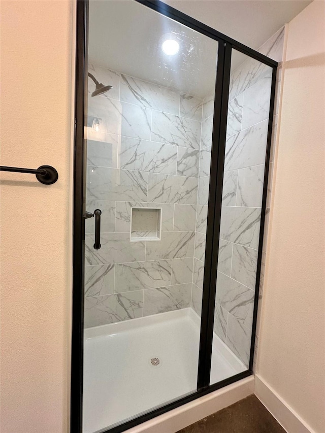 bathroom with a shower with shower door