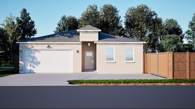 view of front of property featuring fence, driveway, and an attached garage