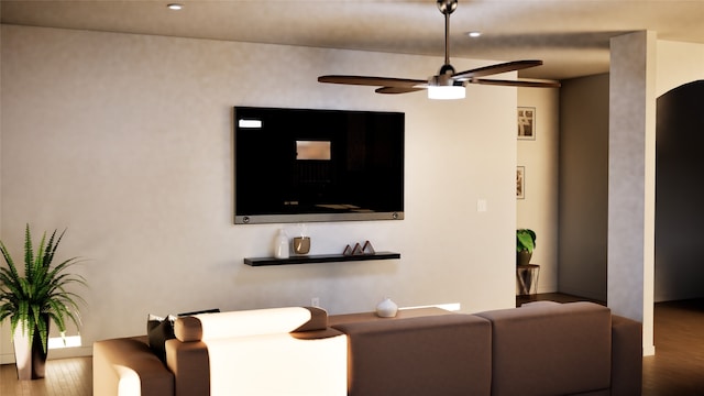 living room with a ceiling fan and wood finished floors