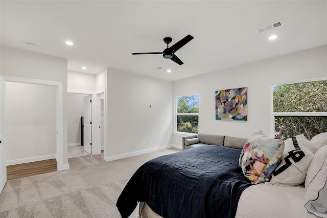 bedroom featuring light colored carpet and ceiling fan