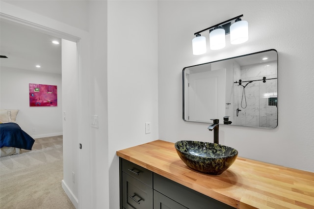 bathroom featuring vanity and tiled shower