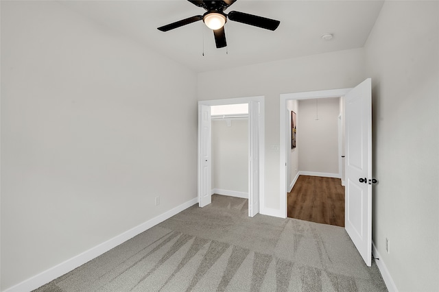 unfurnished bedroom featuring carpet floors, a closet, and ceiling fan