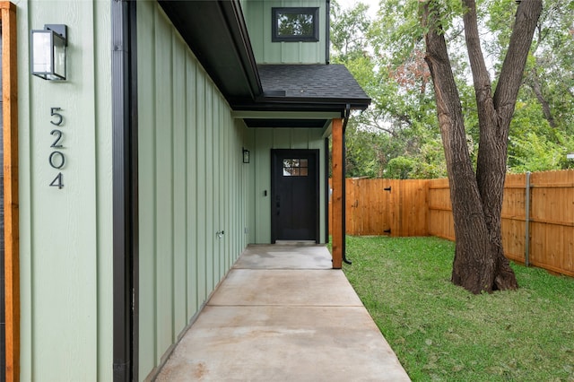 entrance to property with a lawn