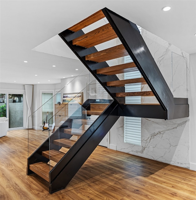 staircase with wood-type flooring