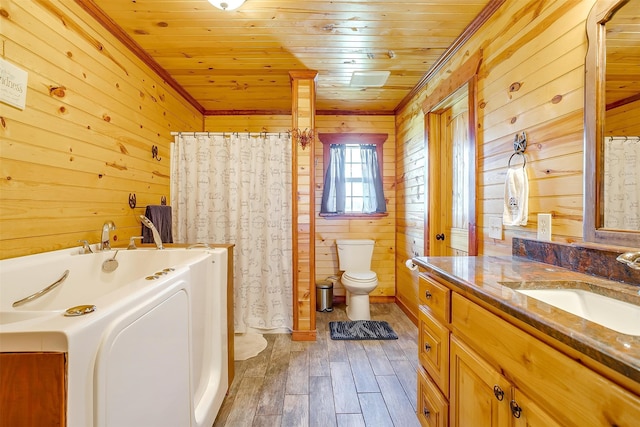 bathroom featuring hardwood / wood-style floors, a bathtub, vanity, wood ceiling, and toilet