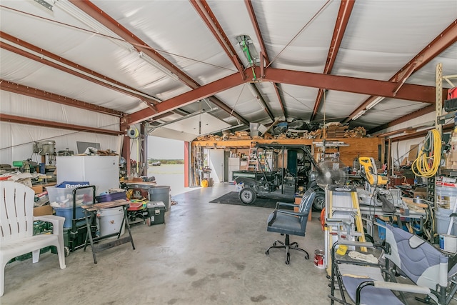 garage with a workshop area and wooden walls