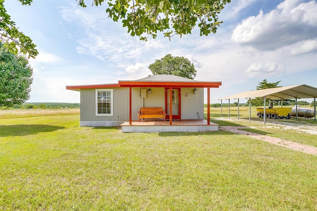 exterior space with a carport, a porch, and a yard