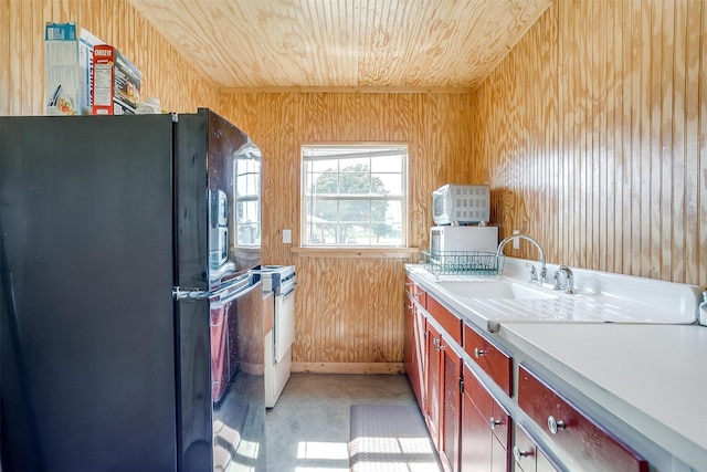 kitchen featuring wooden walls, sink, wooden ceiling, and white appliances