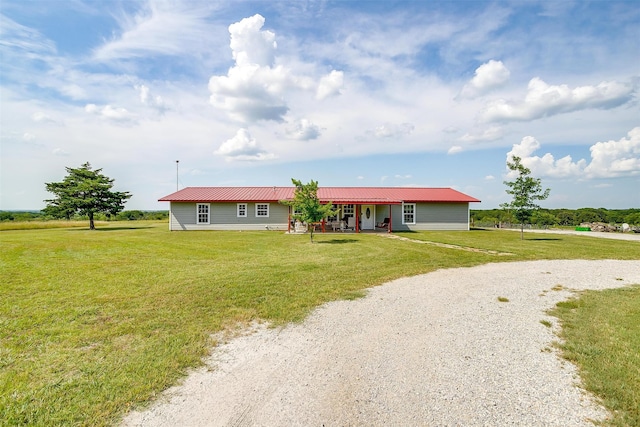 ranch-style home featuring a porch and a front lawn