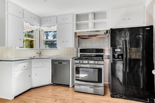 kitchen featuring white cabinets, ventilation hood, stainless steel appliances, and light hardwood / wood-style flooring