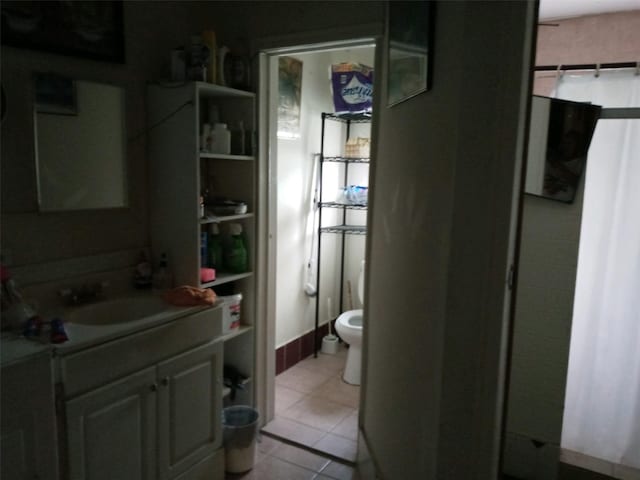 bathroom with tile patterned floors, vanity, and toilet