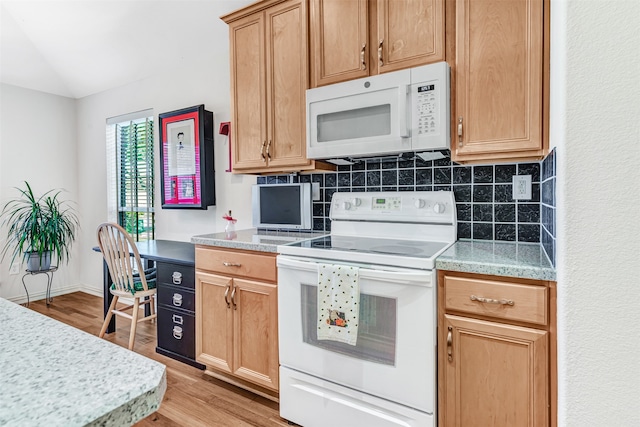 kitchen with tasteful backsplash, white appliances, and light wood-type flooring