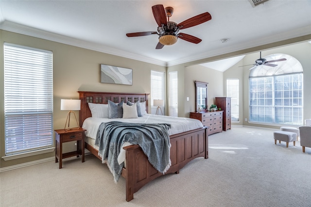 carpeted bedroom with vaulted ceiling, ceiling fan, and ornamental molding