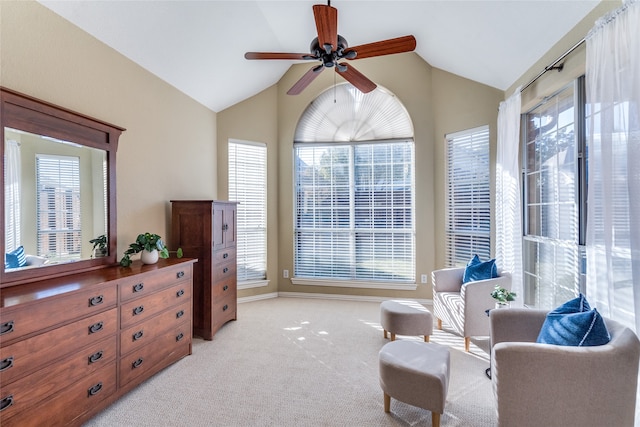 sitting room featuring ceiling fan, light carpet, and vaulted ceiling