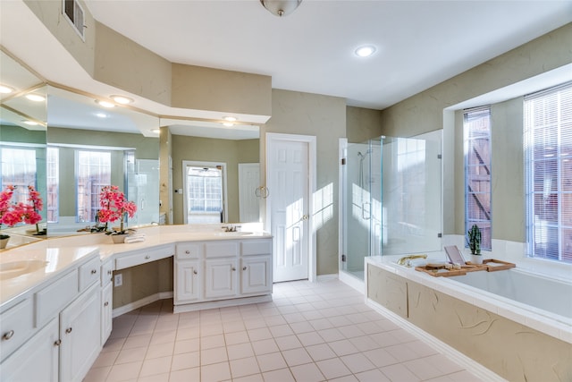 bathroom with shower with separate bathtub, vanity, and a wealth of natural light