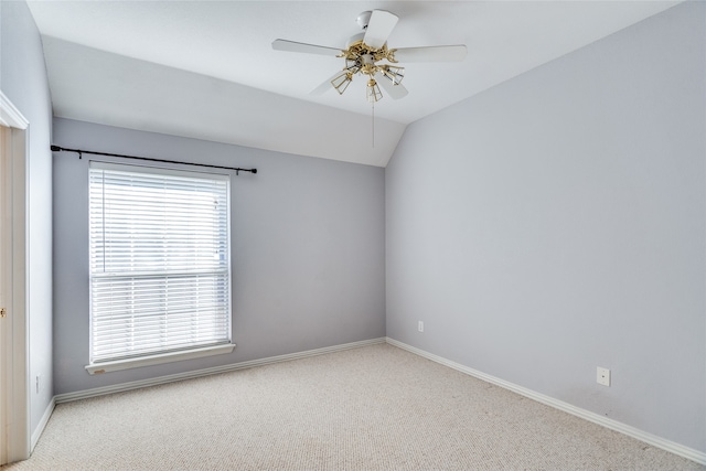 carpeted empty room with ceiling fan and vaulted ceiling