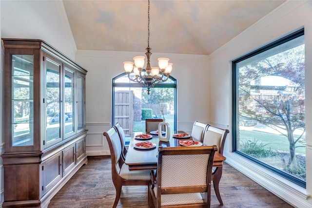 dining area featuring crown molding, dark hardwood / wood-style flooring, a chandelier, and vaulted ceiling