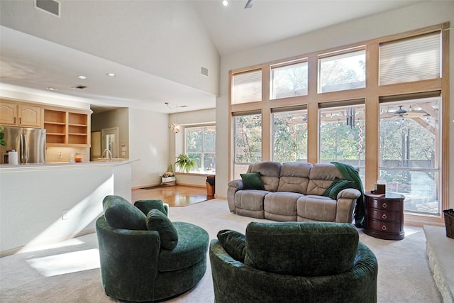 living room featuring ceiling fan and high vaulted ceiling