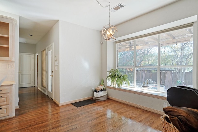 sitting room with an inviting chandelier and dark hardwood / wood-style floors