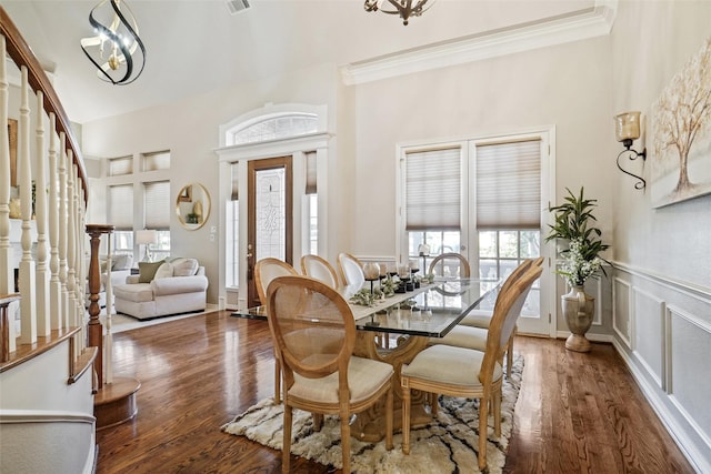 dining room with ornamental molding, dark hardwood / wood-style floors, and a notable chandelier