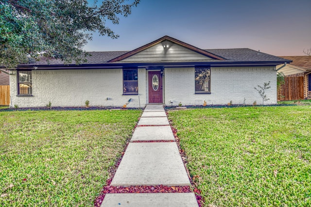 single story home featuring a lawn